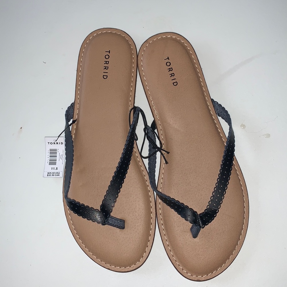 Torrid flat sandals. New with tag. Size 11.5 wide width. Slim black straps.